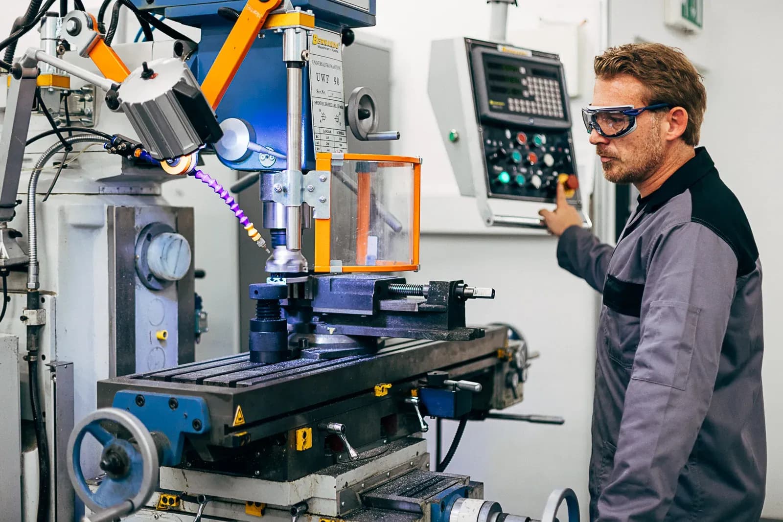 Skilled machinist at a CNC milling centre in the production hall
