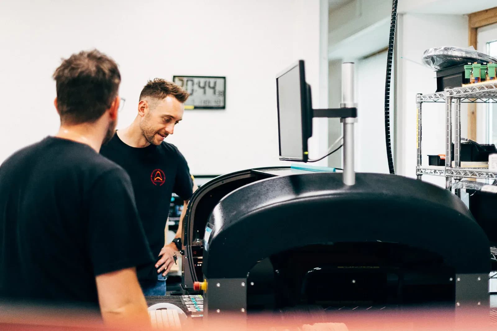 Two Semicore engineers conferring at the electronics production line